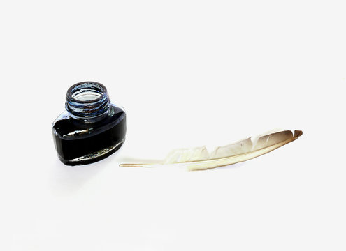 Inkwell and feather quill over white background