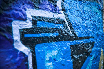 Graffiti detail on a textured brick wall