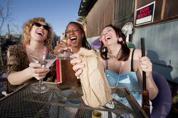 Three women drinking alcohol