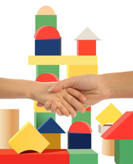mother holding hand of son, toy tower background