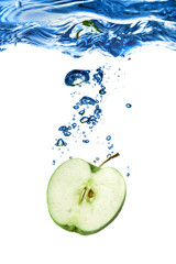 Fototapeta na wymiar green apple dropped into water with bubbles isolated on white