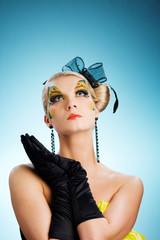 Young beauty with butterfly face-art looking up