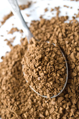 Closeup of the instant coffee in the spoon.
