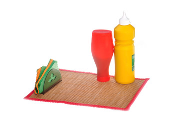 Preparation to meal - mustard and ketchup on mat
