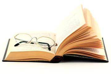 glasses on the open book