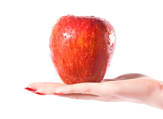 Woman hand with wet red apple