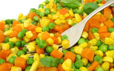 Mixed vegetables carrot, pea and corn with fork