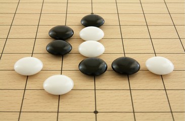 Schwarze und wei&szlig;e Go-Steine auf Brett