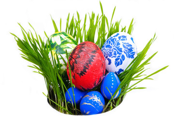 Eggs painted by hand in grass isolated on white background