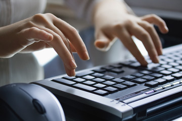 Female hands on the black  keyboard.