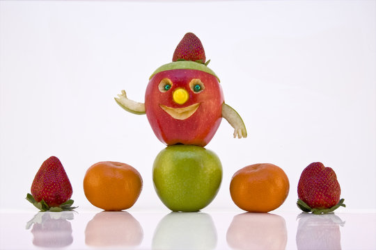 fruit assortment with happy face apple with strawberry hat