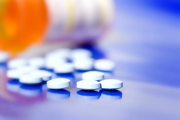 pills pouring from prescription bottle