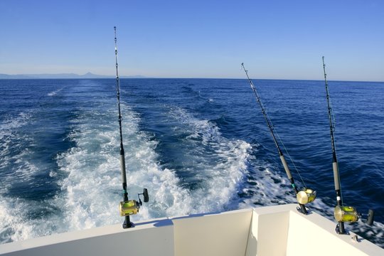 Fishing rod and reel on boat, fishing in blue ocean