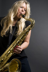 sexy blond female saxophone player musician