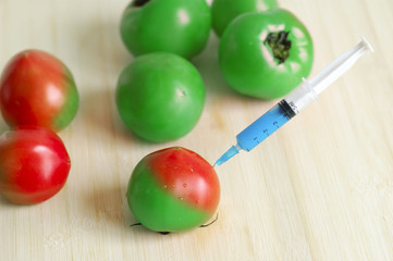 Injecting growth hormone into green tomato