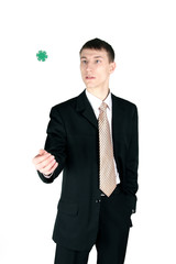 businessman tosses up a chip, isolated on white