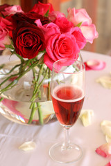 Fototapeta na wymiar Bouquet of roses and glass of champagne