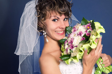 portrait of a young charming bride with her wedding bouquet