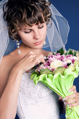 portrait of a young charming bride with her wedding bouquet