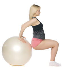 Blond pregnant woman doing pilates.