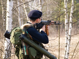 Fototapeta premium Man aiming with rifle in forest