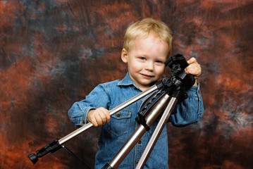 child playing with tripod