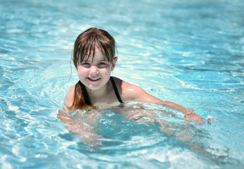Fototapeta na wymiar Playful Young Child in the Pool