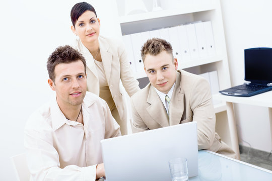 Businesspeople using laptop