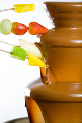 Dipping fruits into a Chocolate