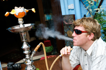 Man smoking a hookah.