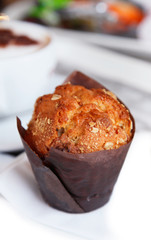 freshly made Muffin with  unfocused coffee cappuchino on backgro