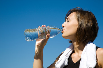 Girl drinking water while exercise