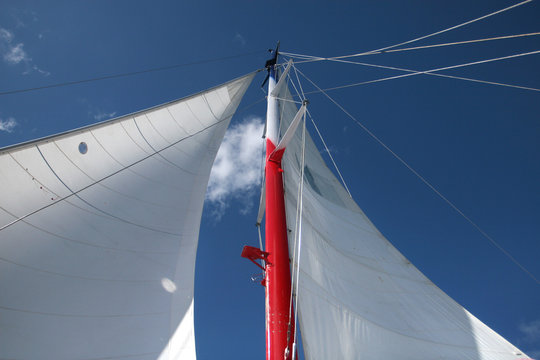 Masts and Sails against Deep Blue Sky: Sailing Adventure