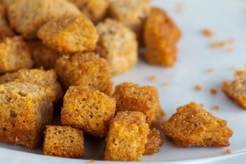 golden dried croutons on the white plate