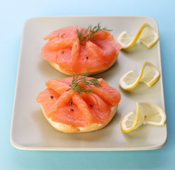 Smoked salmon on bagel with fresh black pepper.