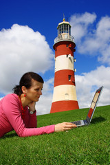 Business Woman with Laptop near the lighthouse