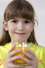 little cute adorable girl seven years old drink orange juice