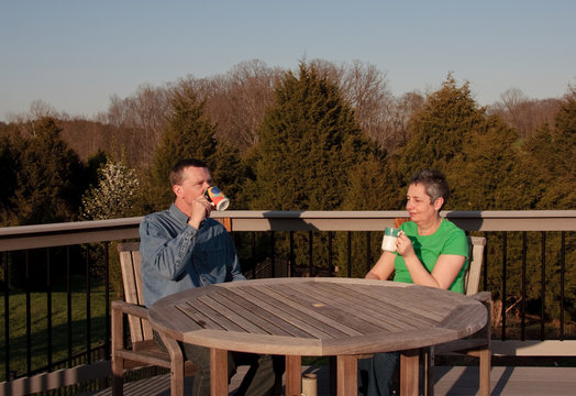 Middle-aged Couple Relaxing On Deck