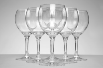 Still-life with empty glasses over white background