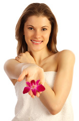 Smiling girl with a flower. Isolated on white