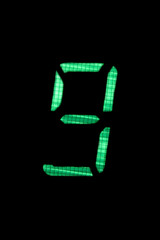 digital number nine in green on black background