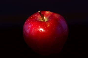 conceptual lit apple on a black background