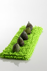 Feigen auf neongruenem Kissen