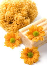 Fototapeta na wymiar natural sponge, soap and flowers