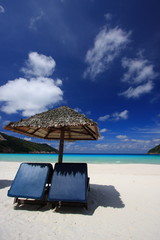 Chairs on a beautiful tropical island beach - 13229790