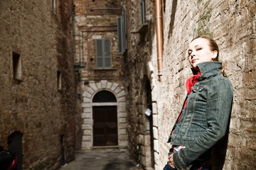 Fototapeta na wymiar Old Italy. Beauty Woman Against Old Wall.