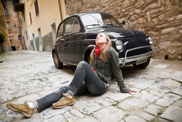 Fototapeta na wymiar Beauty Woman Sitting Against Retro Car. Old Italy Series.