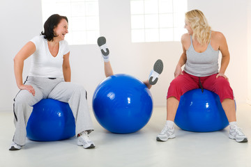 Women on fitness balls