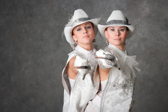 Girls in suits of musketeers