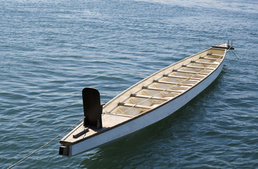 Naklejka premium Tied up rowboat on the blue sea